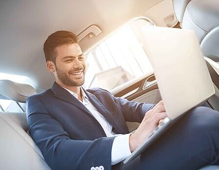 young-man-chatting-with-someone-laughs-his-knees-he-has-laptop